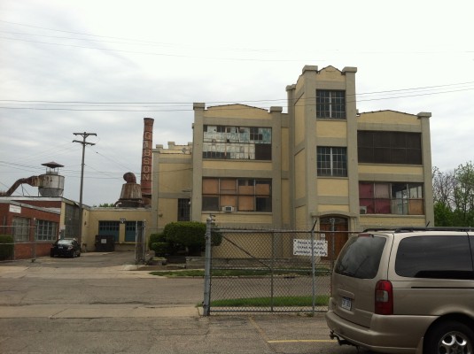 The view of the old Gibson factory from the front of the building. Note the smokestack.